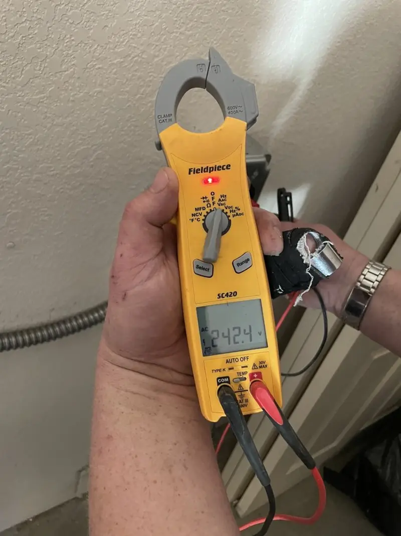 Voltage testing with clamp meter during Outlet Installation in Hollymead